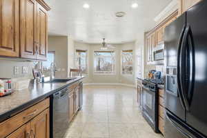 Kitchen featuring black appliances, recessed lighting, ceiling fan, dark countertops, and light tile patterned floors