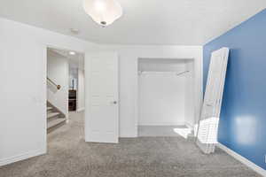 Unfurnished bedroom with carpet floors and a closet