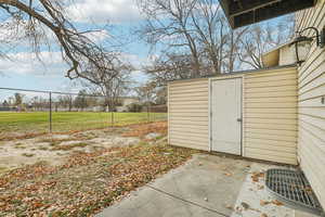 View of yard featuring a patio and a shed