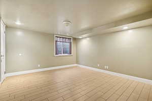 Spare room featuring wood finish floors and recessed lighting