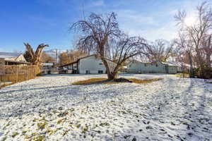 View of snow covered rear of property