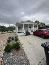 Manufactured / mobile home with a porch and driveway