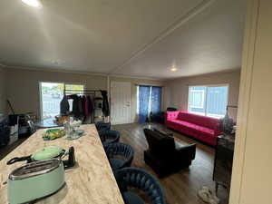 Dining area featuring dark wood-style flooring and crown molding