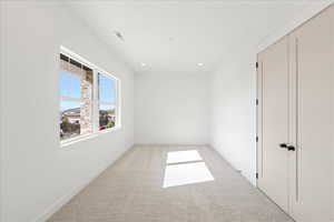 Unfurnished room with carpet and recessed lighting