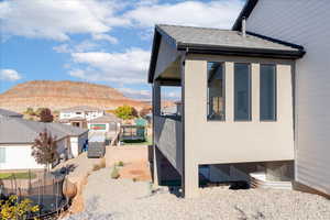 View of property exterior with a trampoline, a mountain view, and a residential view