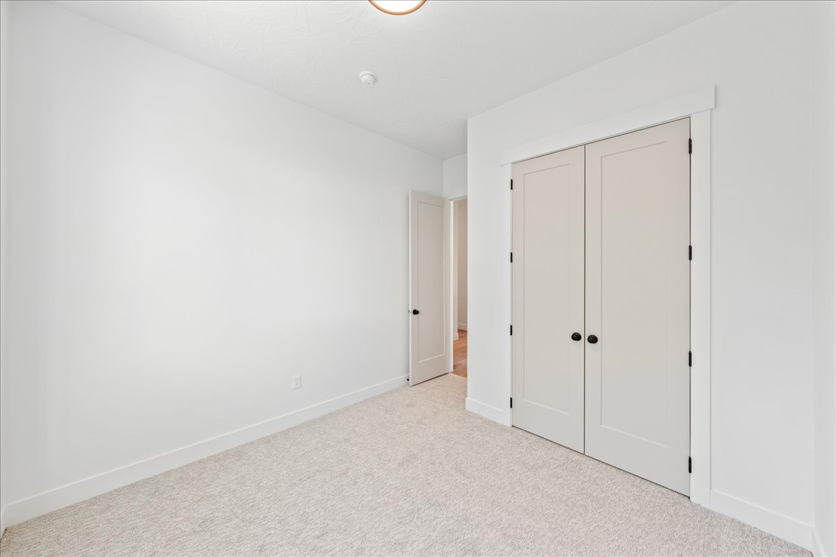 Unfurnished bedroom with a closet and carpet flooring