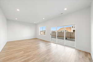 Spare room featuring light wood-style floors and recessed lighting
