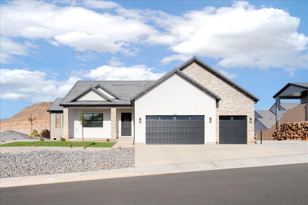 Modern inspired farmhouse featuring covered porch, concrete driveway, a garage, and board and batten siding