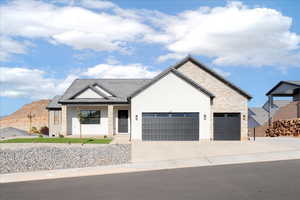 Modern inspired farmhouse featuring covered porch, concrete driveway, a garage, and board and batten siding