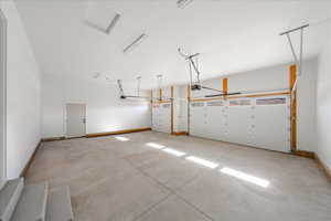 Garage featuring baseboards