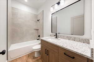Full bathroom featuring vanity, shower / bathtub combination, and light wood finished floors