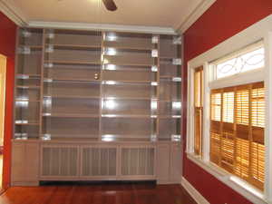 Detailed view of ornamental molding, wood finished floors, and a ceiling fan