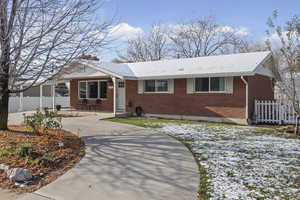 Single story home with brick siding and concrete driveway