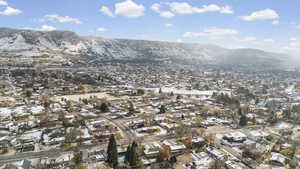 Aerial overview of property's location with nearby suburban area and a mountain backdrop