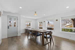 Dining room with hardwood / wood-style floors and recessed lighting