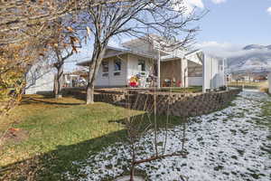 View of snowy exterior featuring a lawn