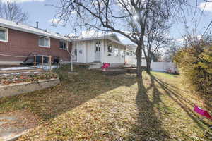 Rear view of house with brick siding