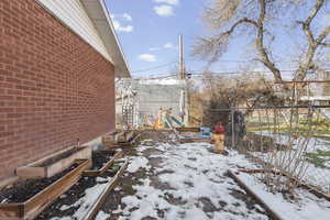 Yard covered in snow with a garden