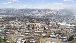 Aerial view of property's location with nearby suburban area and a mountain backdrop
