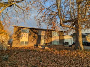 View of front facade featuring brick siding and a garage