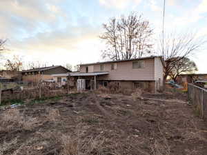 View of back of property at dusk