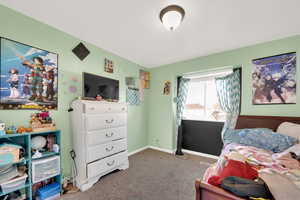 Carpeted bedroom with baseboards