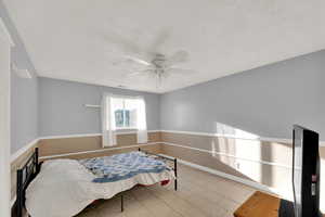 Bedroom featuring ceiling fan and baseboards