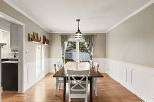 Dining room with wainscotting and sliding glass doors.