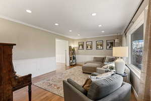 Light and bright front room flows into dining room.