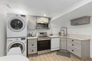 Kitchen with full-sized appliances, quartz countertops and over-the-range microwave.