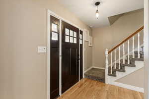 Entryway with new door and new hardwood floors.