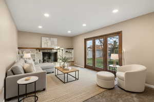Main floor family room with new carpet and gas fireplace. Virtually staged to show potential.