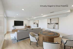 Living room with recessed lighting and light wood-style floors