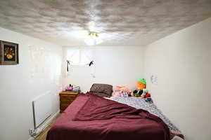 Bedroom featuring a textured ceiling