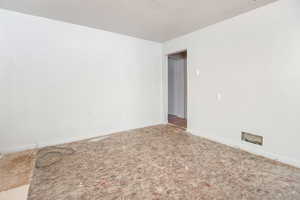 Unfurnished room featuring baseboards