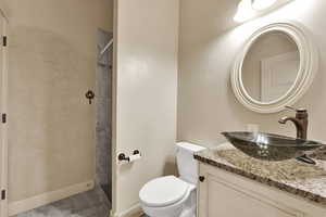 Bathroom featuring vanity, a shower stall, and light tile patterned floors