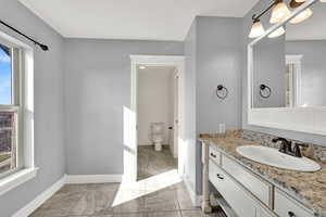 Bathroom with vanity and baseboards