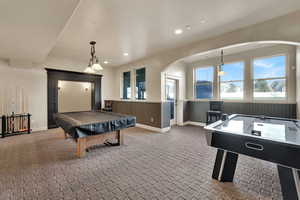 Playroom with billiards table, a wainscoted wall, recessed lighting, and arched walkways