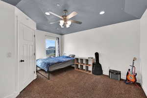 Carpeted bedroom with ceiling fan and recessed lighting