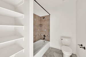 Full bathroom featuring shower / tub combination and toilet