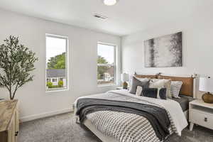Carpeted bedroom with baseboards and a textured ceiling