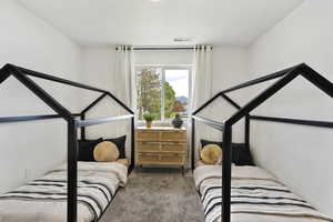 Bedroom with carpet and a textured ceiling