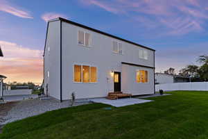 Rear view of property featuring a patio area and stucco siding