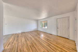 Unfurnished living room featuring hardwood flooring,