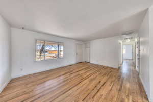 Living room with healthy amount of natural light and hardwood flooring