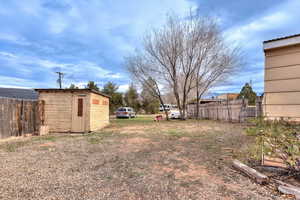View of  side yard with a storage shed
