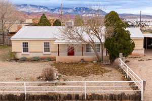 Ranch-style home with a mountain view, a metal roof, and covered front porch