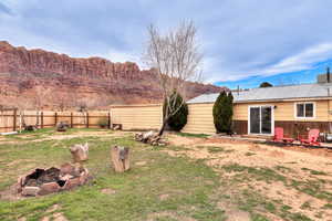 Fenced backyard with a fire pit
