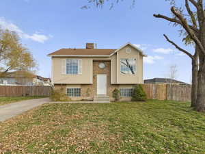 Split foyer home with brick siding and a chimney