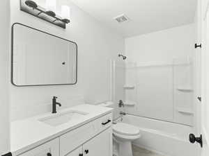 Bathroom featuring shower / washtub combination and vanity